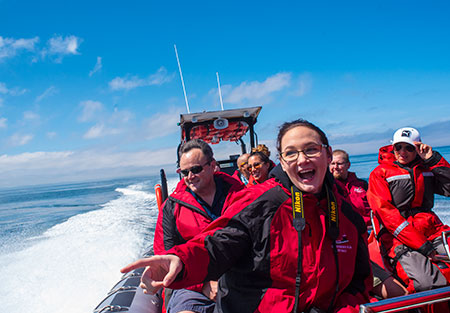 Passengers Smiling as the Wind Blows them Away on their Jolly Breeze Jet Boat Tour in Saint Andrews, New Brunswick