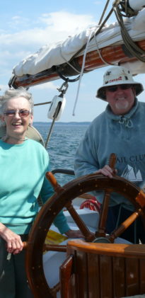 Whale Watching Passengers Bob and Jean Steering the Ship on the Bay of Fundy, New Brunswick