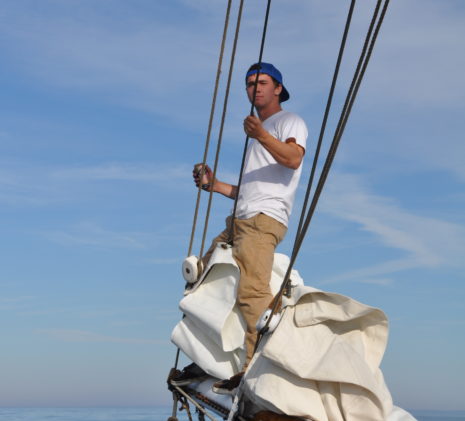 Jolly Breeze Crew Member Dave Standing on the Bow Spirit at Sea