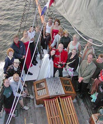 A Group Wedding Photo at the Bow of the Jolly Breeze Whale Watching Sailboat, Saint Andrews, New Brunswick